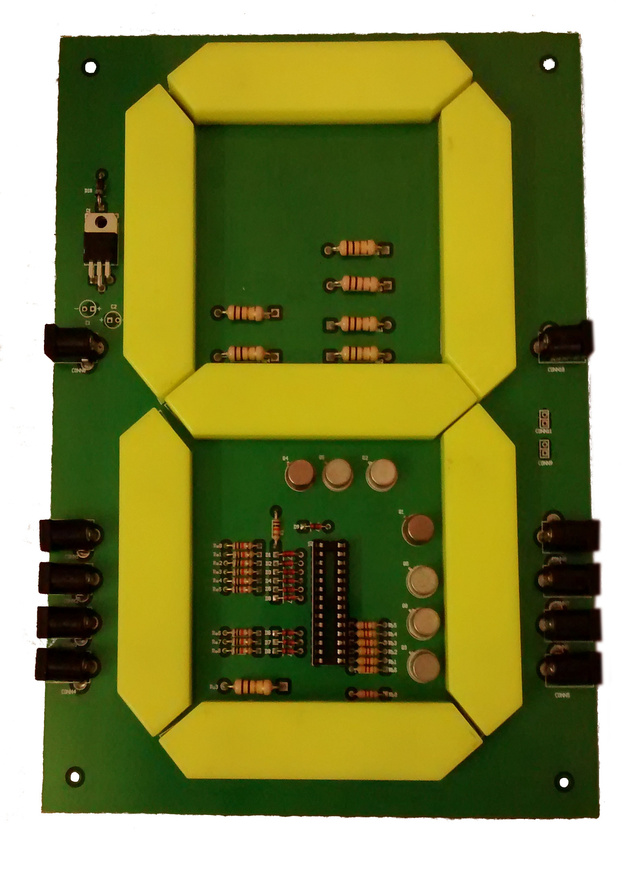 Printed circuit board dominated by a seven segment display, with 5 DC jacks on either side and control circuitry in the center
